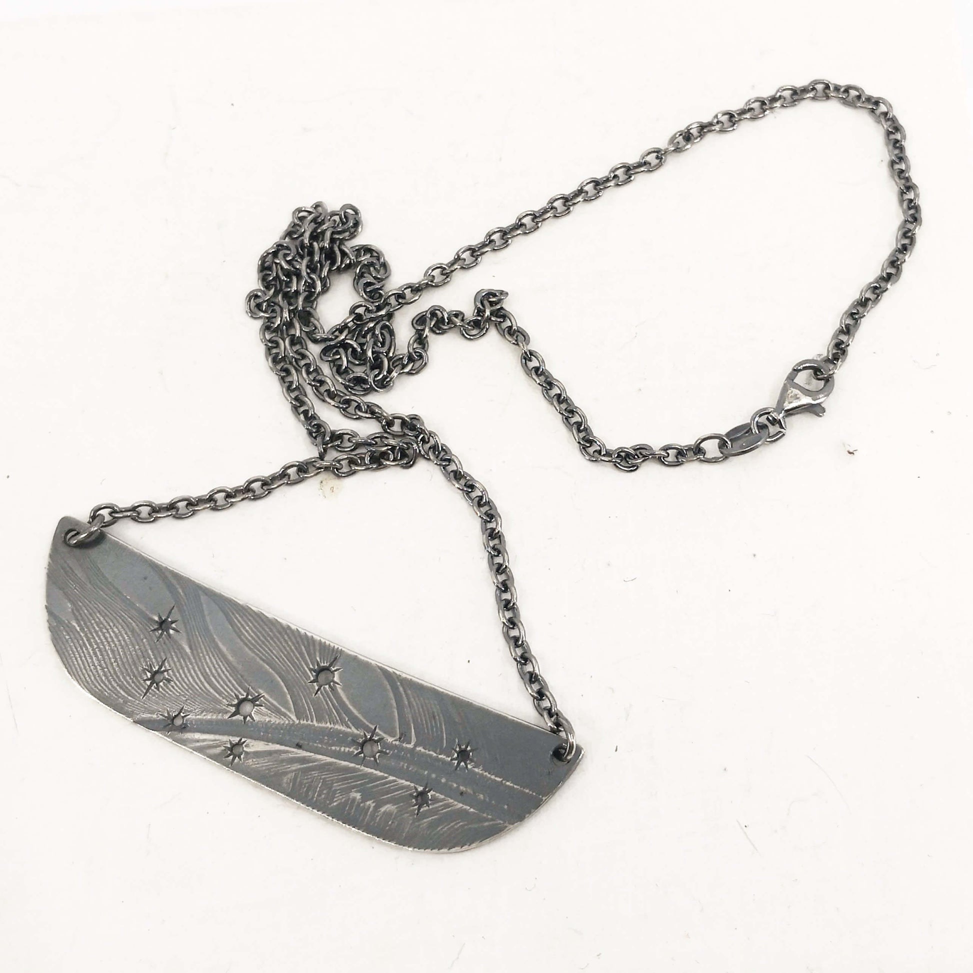 The Matariki Necklace in oxidised sterling silver by NZ jeweller Buster Collins.