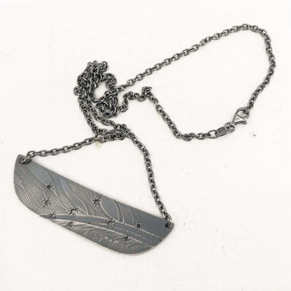 The Matariki Necklace in oxidised sterling silver by NZ jeweller Buster Collins.