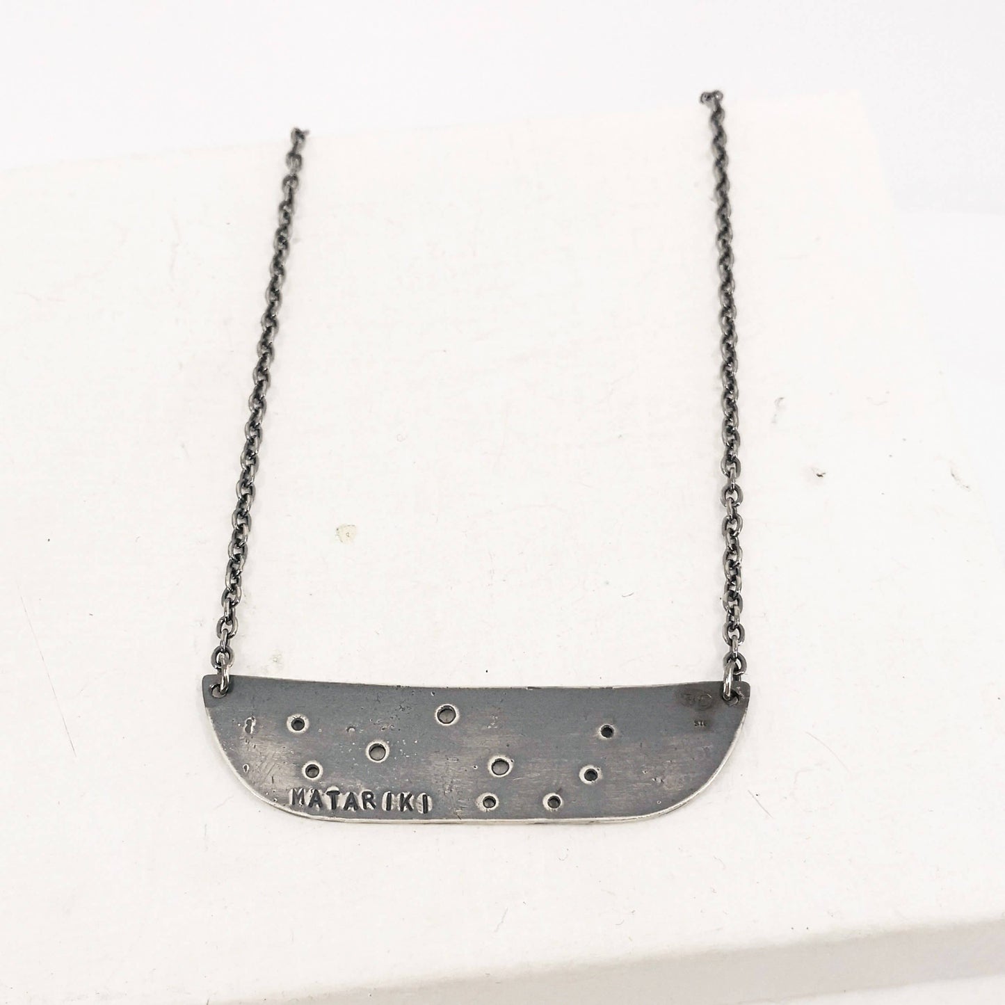 The Matariki Necklace in oxidised sterling silver by NZ jeweller Buster Collins.