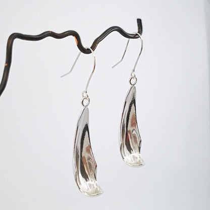 The silver petal earrings by NZ jeweller Buster Collins are simple and sleek easy-to-wear jewellery.