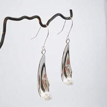 Load image into Gallery viewer, The silver petal earrings by NZ jeweller Buster Collins are simple and sleek easy-to-wear jewellery.
