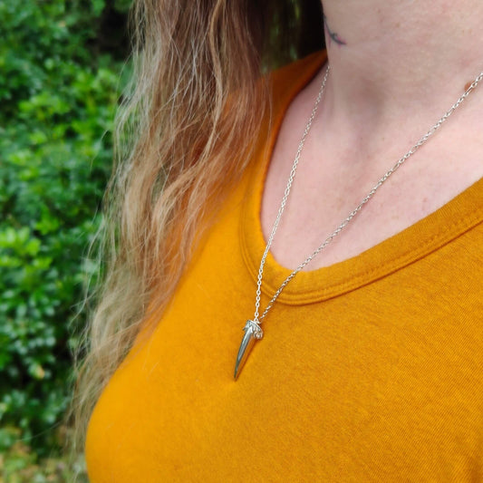 The Ruru Talon pendant is a hand carved silver charm in the shape of a small claw. The Ruru is the native owl of NZ, a small and shy bird with a distinctive call. 