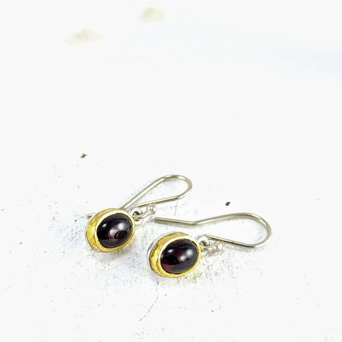 These oval garnet earrings in sterling silver and 22carat yellow gold are hand crafted in NZ by David McLeod. Handmade NZ jewellery available at Mason & Collins. 