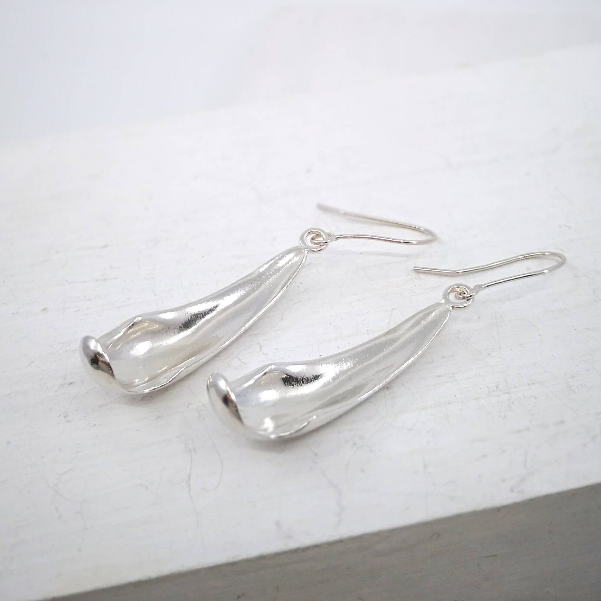 The silver petal earrings by NZ jeweller Buster Collins are simple and sleek easy-to-wear jewellery.