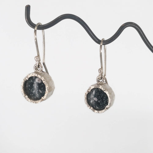 The Round Drop silver earrings from David McLeod set with a speckled polished granite. Handmade NZ earrings available at Mason & Collins.