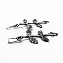 Load image into Gallery viewer, The spring leaf earrings by Herbertandwilks Jewellery are hand crafted in sterling silver Five small leaves sprout from a long stem and they hang from handmade silver hooks.
