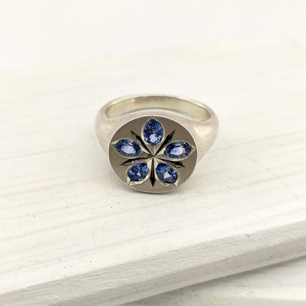 The beautiful Star Flower Borage ring is hand crafted by Adele Stewart in solid sterling silver and ceylon sapphires.