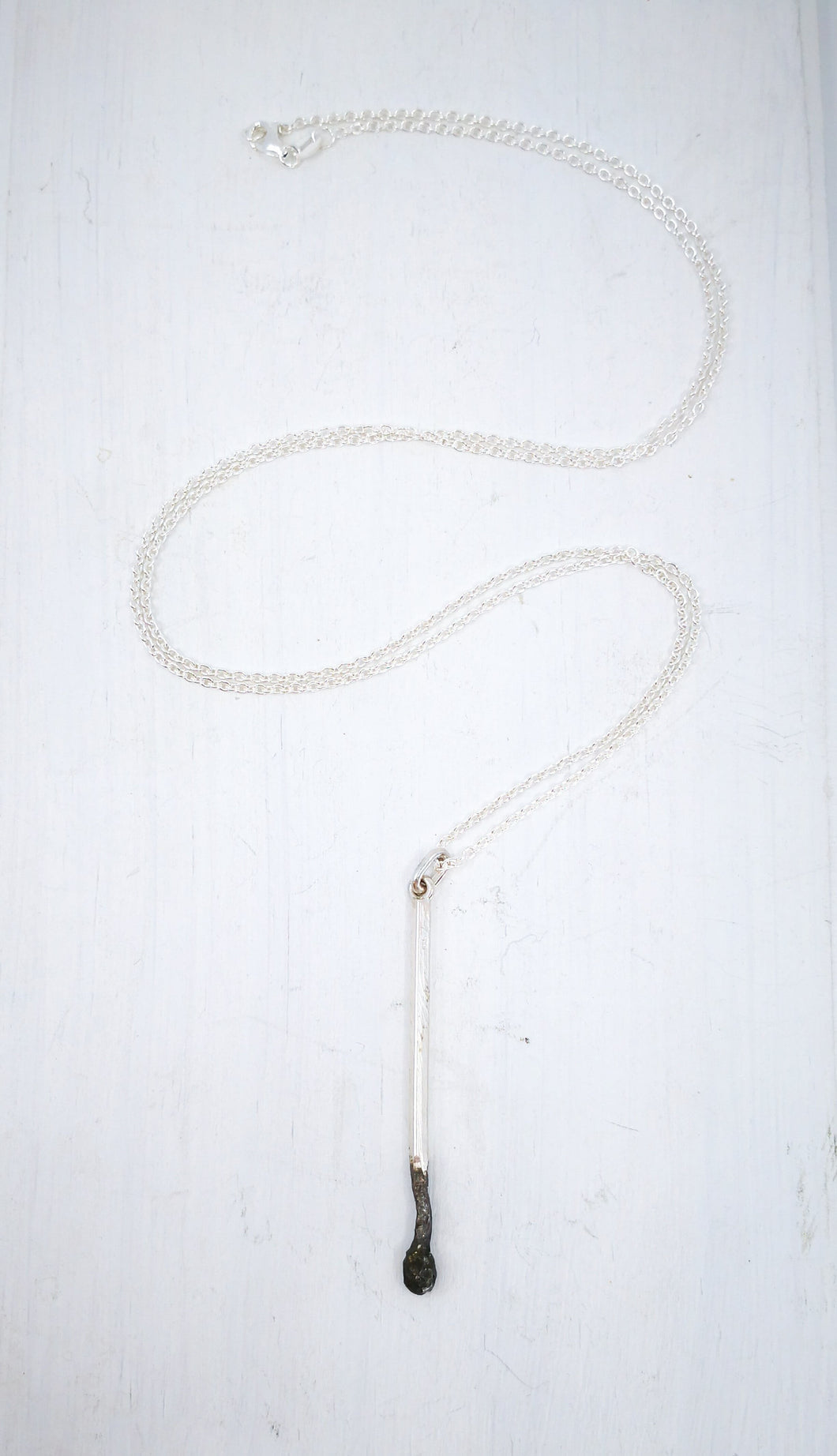 The Burnt Match pendant hand crafted by David McLeod, an icon in NZ jewellery.