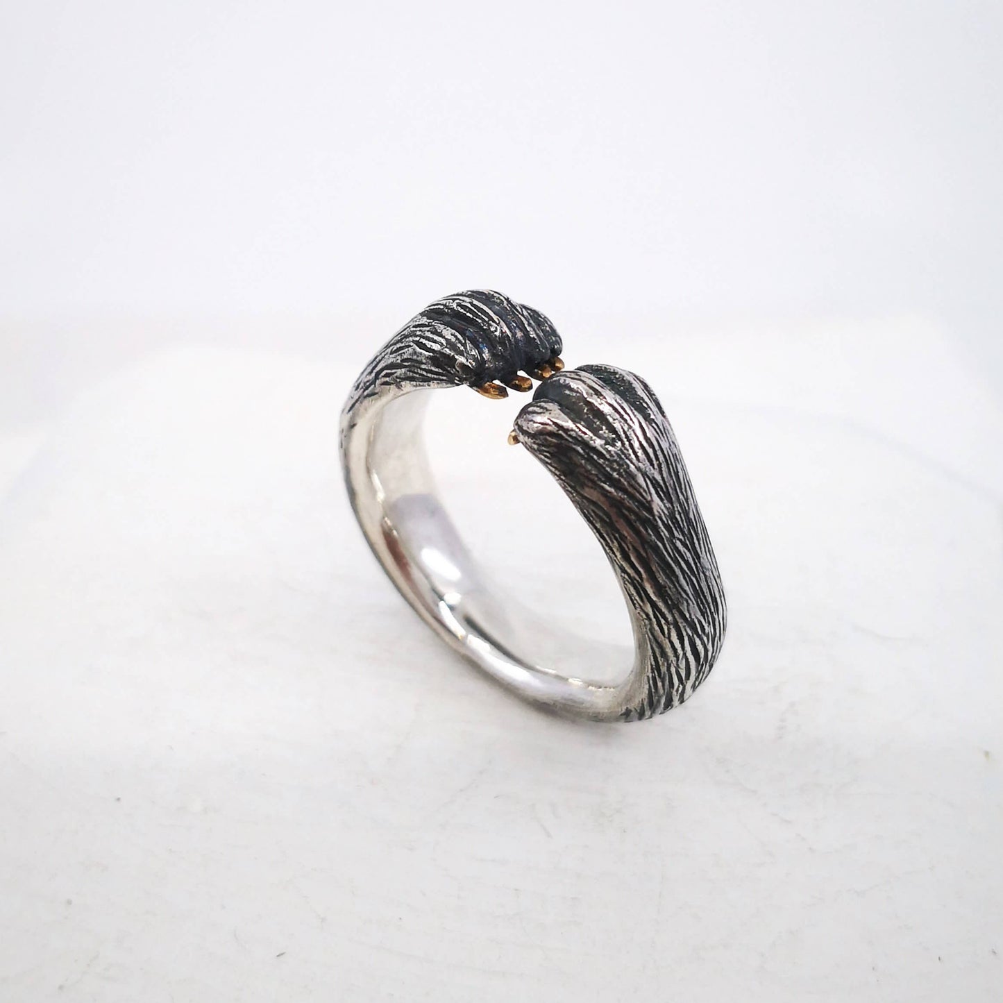 The Bear Hug Ring by NZ jeweller Vaune Mason is hand crafted in solid sterling silver with claws in 9ct yellow gold.