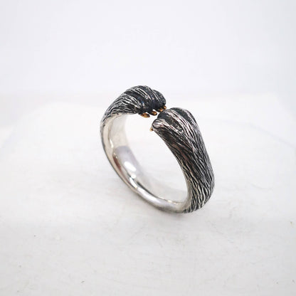 The Bear Hug Ring by NZ jeweller Vaune Mason is hand crafted in solid sterling silver with claws in 9ct yellow gold.