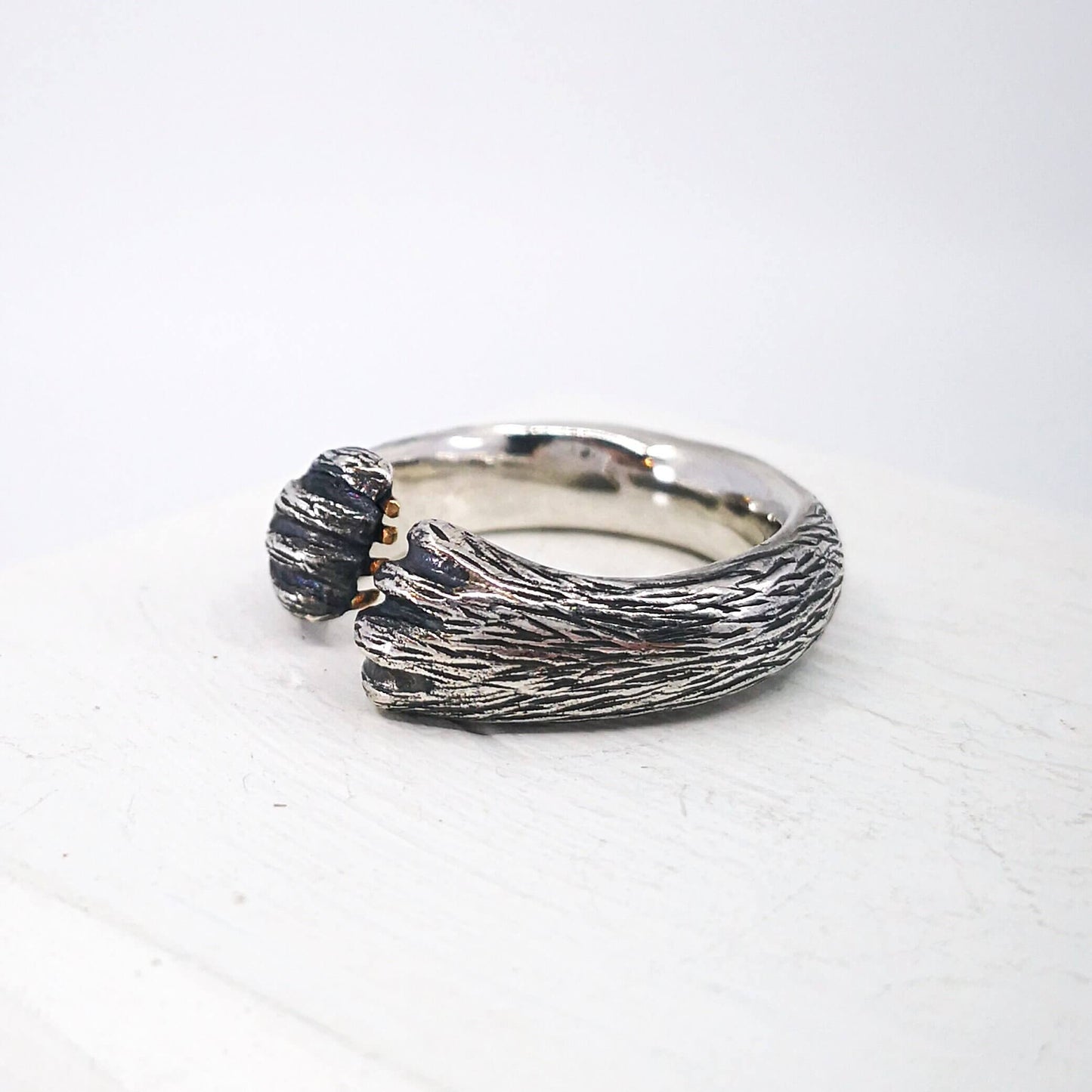 The Bear Hug Ring by NZ jeweller Vaune Mason is hand crafted in solid sterling silver with claws in 9ct yellow gold.