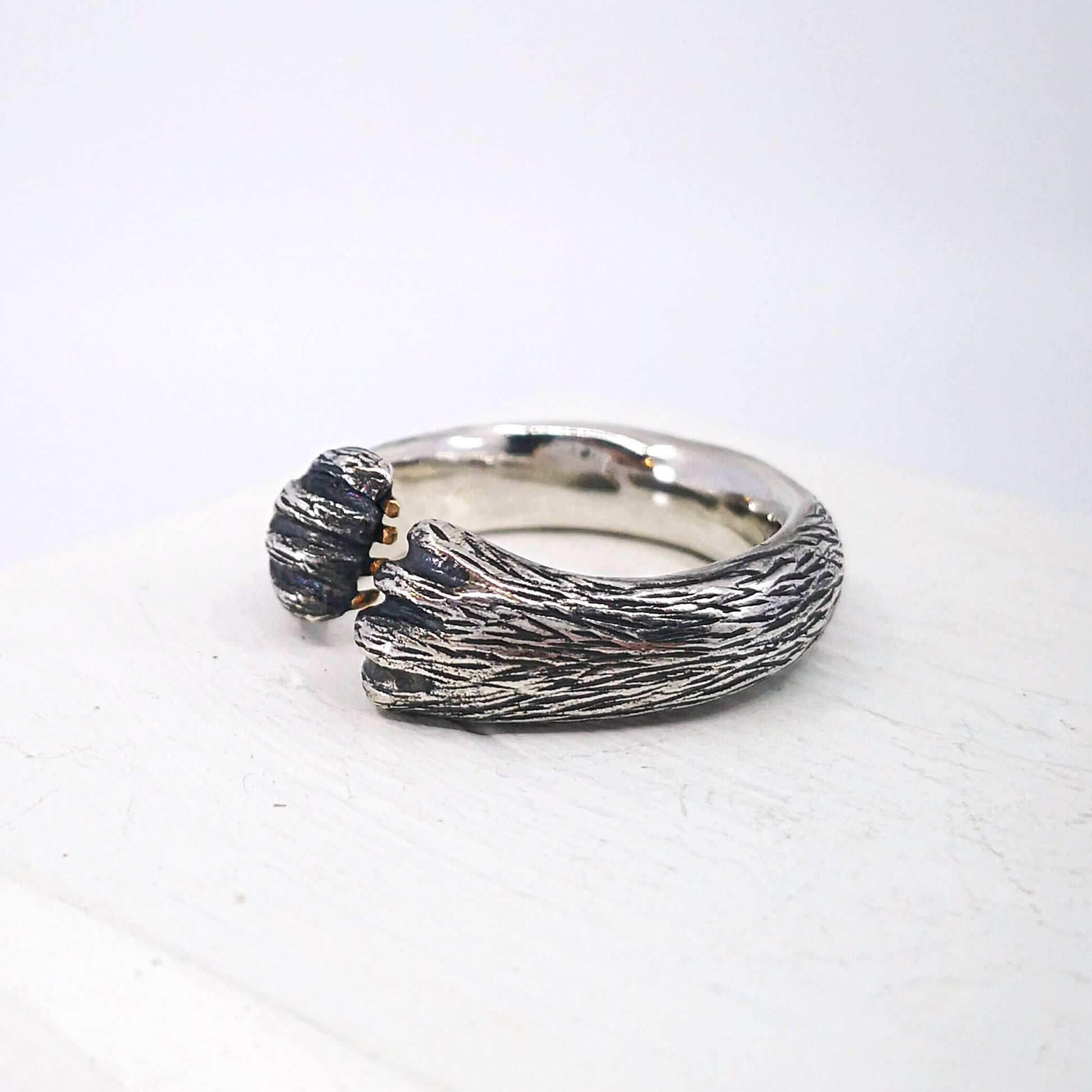 The Bear Hug Ring by NZ jeweller Vaune Mason is hand crafted in solid sterling silver with claws in 9ct yellow gold.