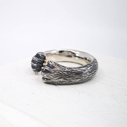 The Bear Hug Ring by NZ jeweller Vaune Mason is hand crafted in solid sterling silver with claws in 9ct yellow gold.