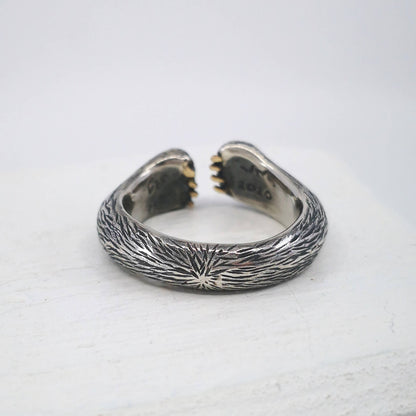 The Bear Hug Ring by NZ jeweller Vaune Mason is hand crafted in solid sterling silver with claws in 9ct yellow gold.