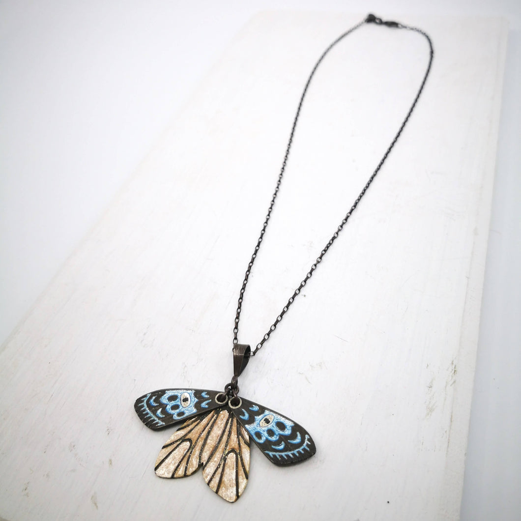 The beautiful Gypsy Moth pendant by Adele Stewart features moving wings coloured with glass enamels and set with tiny black diamonds.