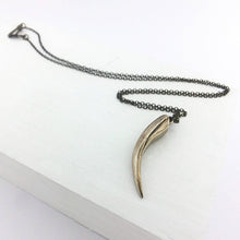 Load image into Gallery viewer, The Huia Beak charm pendant features a small curved beak pendant based on the distinctive curved bill of the now extinct Huia Bird. Handmade in NZ by The Wild Jewellery.
