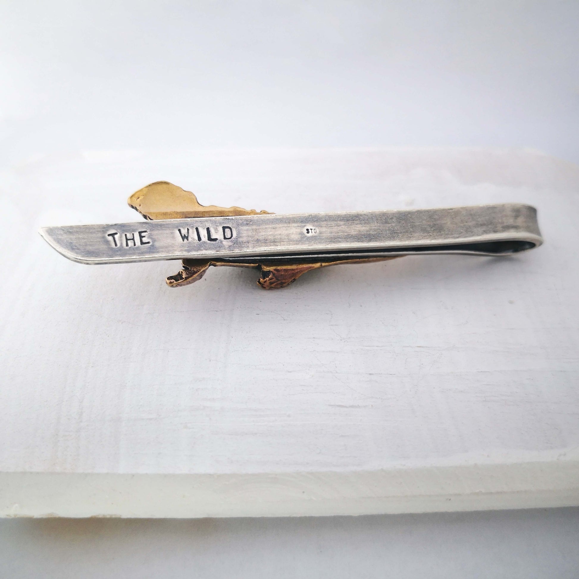 The Tuatara Tie Slide in sterling silver and bronze with a light oxidised finish is hand crafted in NZ by The Wild Jewellery.