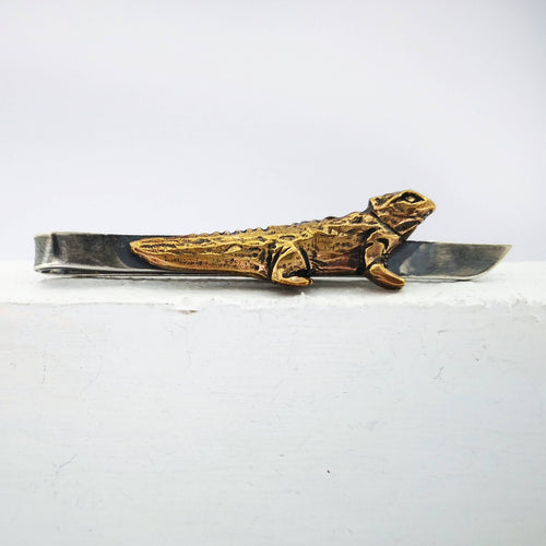 The Tuatara Tie Slide in sterling silver and bronze with a light oxidised finish is hand crafted in NZ by The Wild Jewellery.
