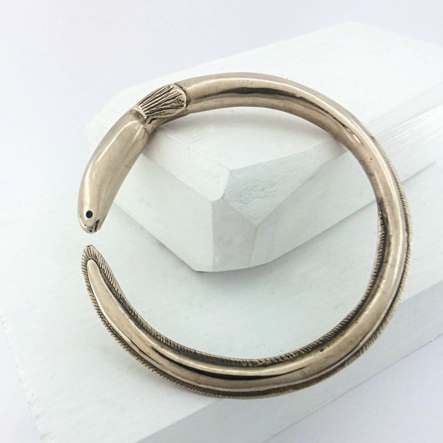 The tuna bracelet is handmade in NZ by The Wild Jewellery. Cast in warm bronze this bracelet represents the endangered long-finned eel that is native to Aotearoa NZ.