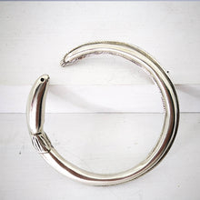 Load image into Gallery viewer, The tuna bracelet is handmade in NZ by The Wild Jewellery. Cast in solid sterling silver this bracelet represents the endangered long-finned eel that is native to Aotearoa NZ.
