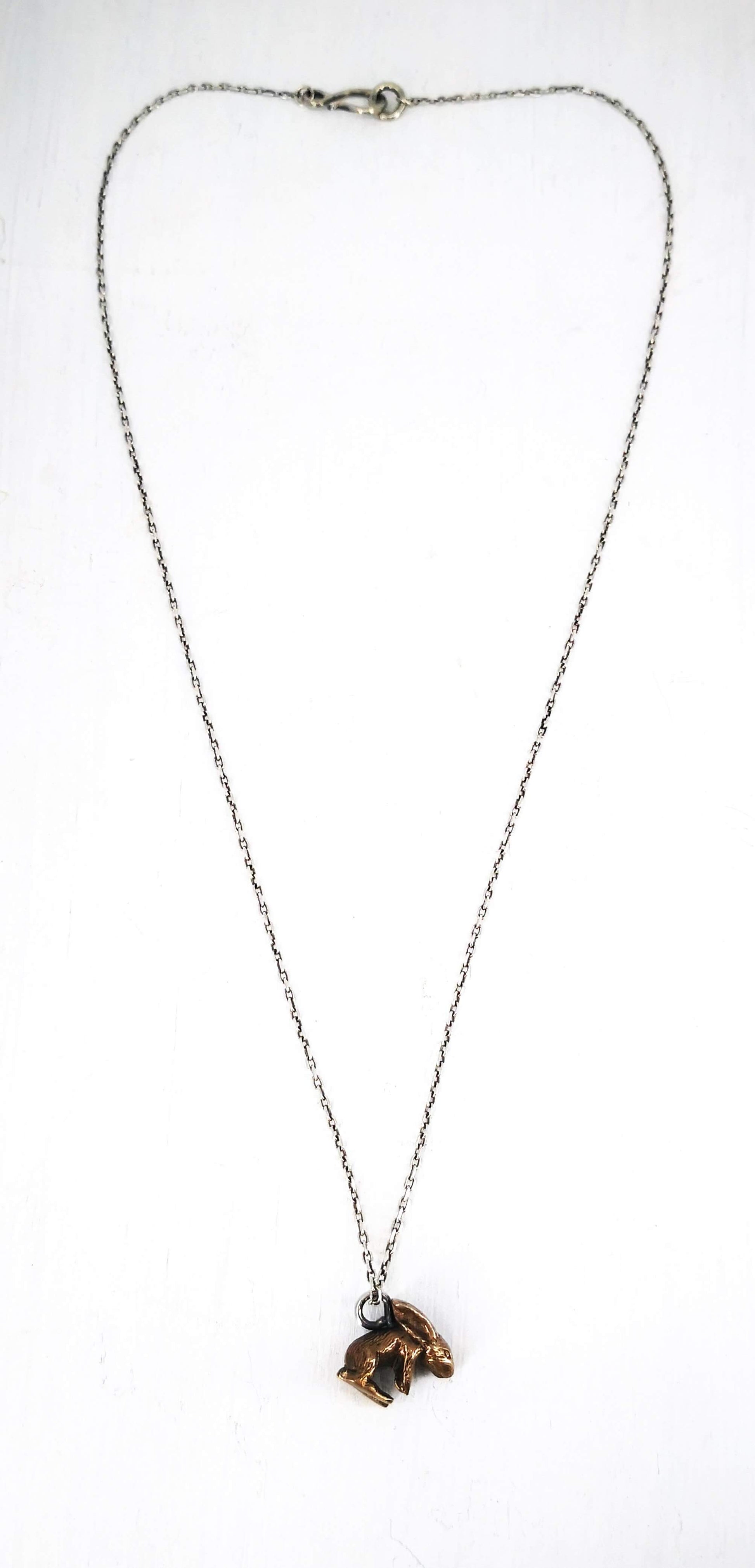 The Very Tiny Bunny necklace by Vaune Mason features a delicately carved bunny charm cast in warm bronze on a sterling silver chain.